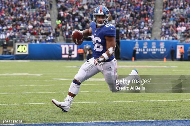 Running back Saquon Barkley of the New York Giants runs the ball to score a touchdown against the Tampa Bay Buccaneers in the first quarter at...