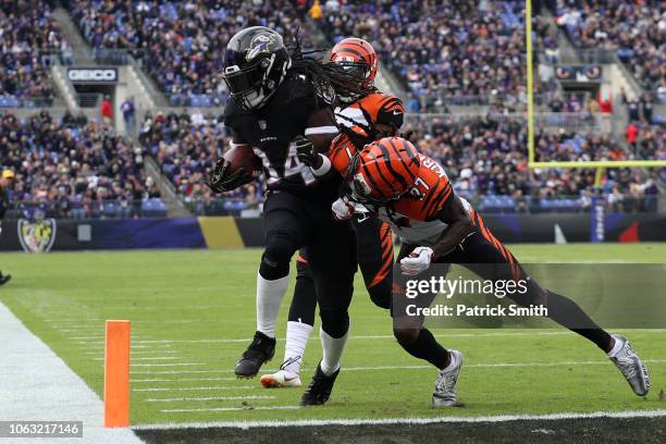 Running Back Alex Collins of the Baltimore Ravens rushes for a touchdown in the first quarter against the Cincinnati Bengals at M&T Bank Stadium on...