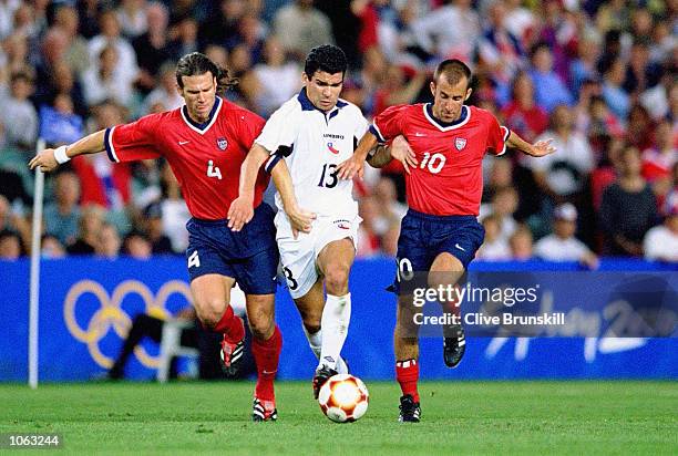 Rodrigo Nunez of Chile takes on Jeff Agoos and Pete Vagenas of the USA in the Mens Football Bronze Medal Match at the Sydney Football Stadium on Day...