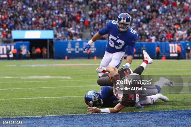 Quarterback Ryan Fitzpatrick of the Tampa Bay Buccaneers makes a touchdown against safety Landon Collins of the New York Giants in the second quarter...