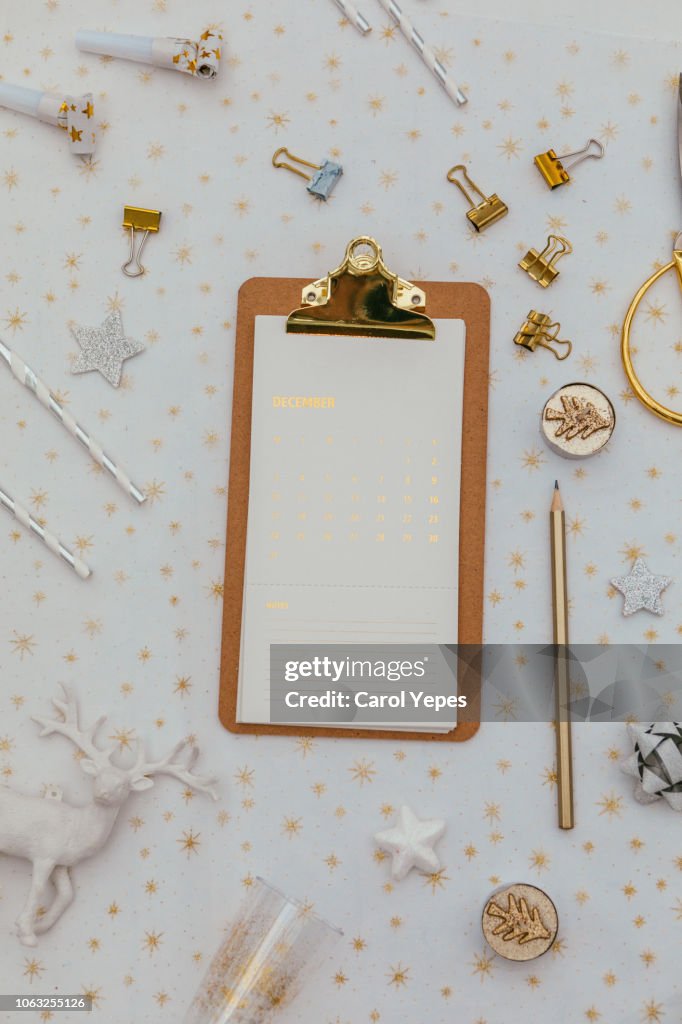 Eyeglasses and golden clippboard on desktop