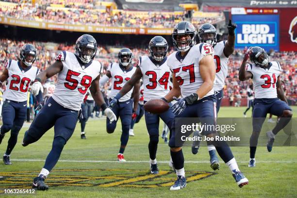 Brennan Scarlett of the Houston Texans celebrates with teammates after intercepting a pass in the second quarter of the game against the Washington...