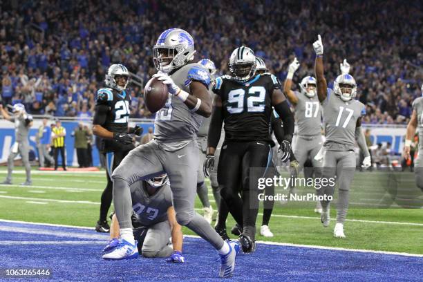 Detroit Lions running back Kerryon Johnson scores a run during the first half of an NFL football game against the Carolina Panthers in Detroit,...