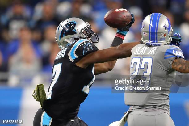 Devin Funchess of the Carolina Panthers grabs a pass in front of Darius Slay of the Detroit Lions during the first half at Ford Field on November 18,...