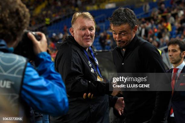 Bosnia-Herzegovina's coach Robert Prosinecki shakes hands with Spain's coach Luis Enrique before the international friendly football match between...