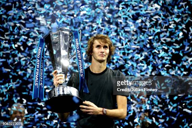 Alexander Zverev of Germany celebrates victory with the trophy following the singles final against Novak Djokovic of Serbia during Day Eight of the...