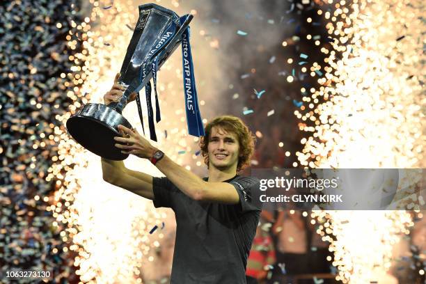 Germany's Alexander Zverev holds up the trophy after beating Serbia's Novak Djokovic in their men's singles final match on day eight of the ATP World...