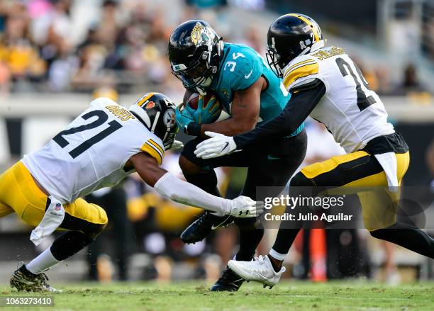 Carlos Hyde of the Jacksonville Jaguars is brought down by Sean Davis of the Pittsburgh Steelers and Coty Sensabaugh of the Pittsburgh Steelers...