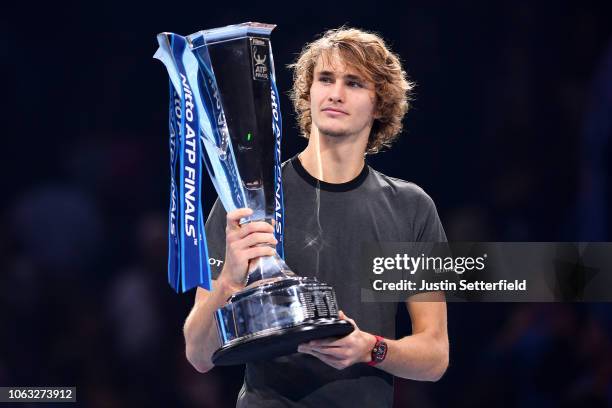 Alexander Zverev of Germany celebrates victory with the trophy following the singles final against Novak Djokovic of Serbia during Day Eight of the...