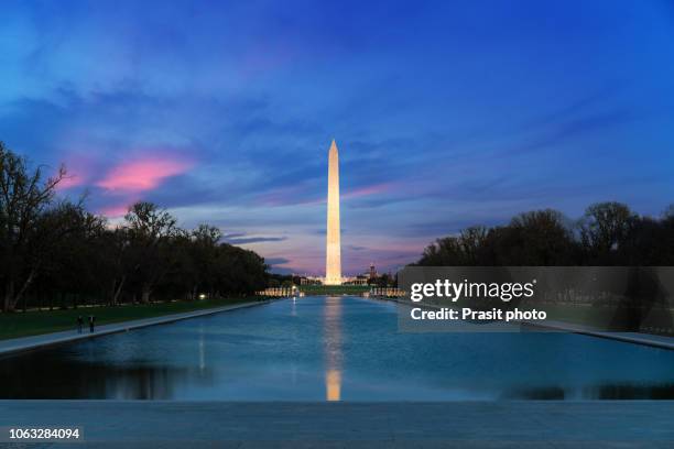 washington monument with lake at night with dramatic clouds in washington dc, usa. - washington dc sunset stock pictures, royalty-free photos & images