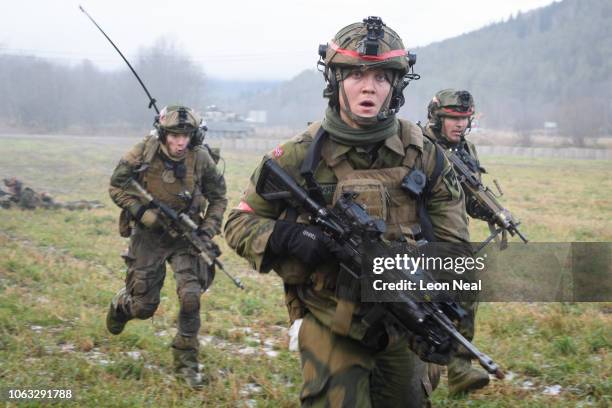 Norwegian soldiers run for cover during an attempt to storm an opposing British Army position, during the live exercise on November 3, 2018 in Elval,...