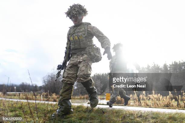 British soldiers from Anzio Company of the Duke of Lancaster Regiment rush to a ditch while under enemy fire, during the live exercise on November 3,...