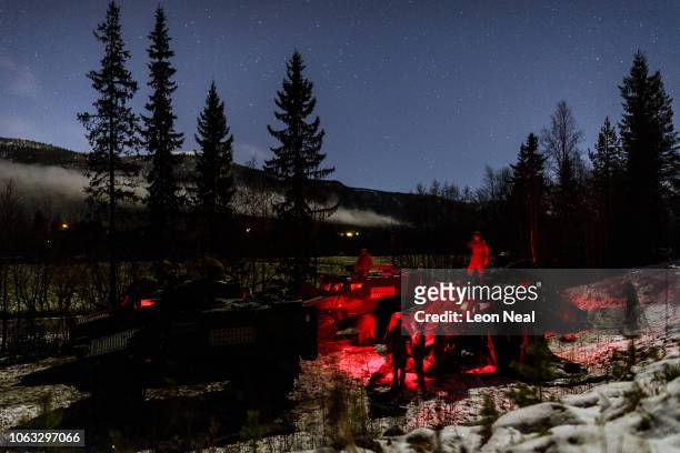 British Army Foxhound armoured vehicles from B Company of the Royal Irish Regiment are seen under the night sky as the group establishes camp during...