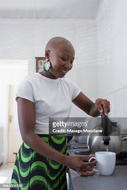 Woman pouring water in the kitchen