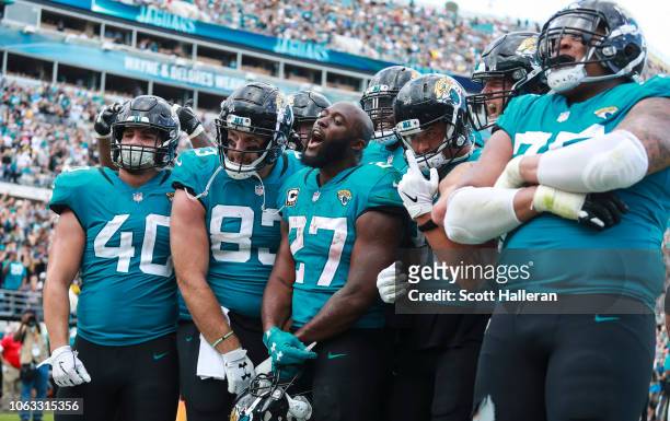 Leonard Fournette of the Jacksonville Jaguars celebrates with the Jacksonville Jaguars offense following a second half touchdown against the...