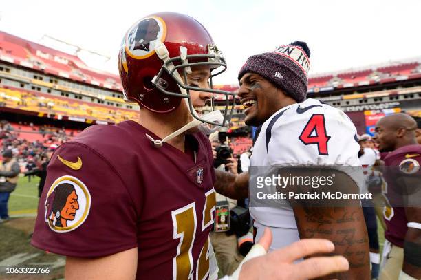 Colt McCoy of the Washington Redskins and Deshaun Watson of the Houston Texans talk after the Texans defeated the Redskins 23-21 at FedExField on...