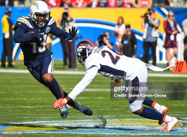 Wide receiver Keenan Allen of the Los Angeles Chargers runs the ball after a complete pass in front of strong safety Darian Stewart of the Denver...