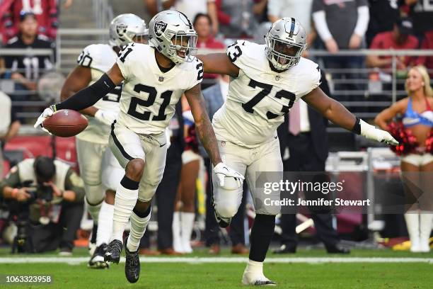 Gareon Conley of the Oakland Raiders celebrates an interception with Maurice Hurst in the first half of the NFL game against the Arizona Cardinals at...