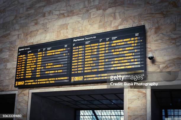 departures and arrivals timetable, inside the railway station of florence, italy - tabellone arrivi e partenze foto e immagini stock