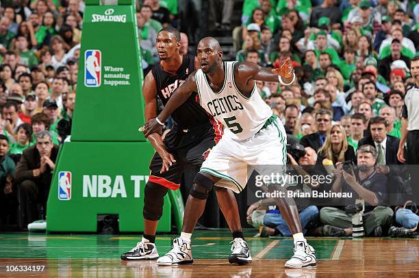 Kevin Garnett of the Boston Celtics looks for the ball against Chris Bosh of the Miami Heat during the season opening game on October 26, 2010 at the...