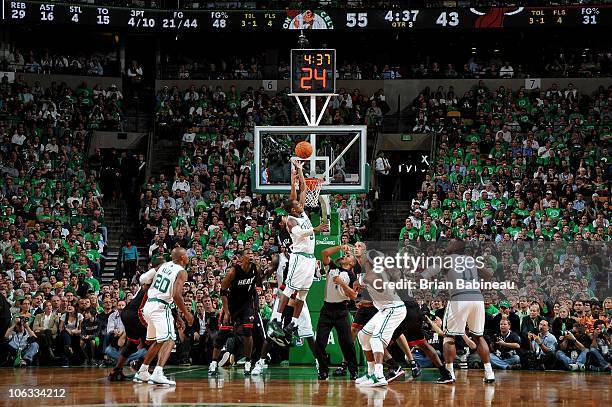 Rajon Rondo of the Boston Celtics and Eddie House of the Miami Heat jump for the ball during the season opening game on October 26, 2010 at the TD...