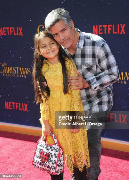 Actor Esai Morales daughter and Mariana Oliveira Morales arrive for the Premiere Of Netflix's "The Christmas Chronicles" held at Fox Bruin Theater on...