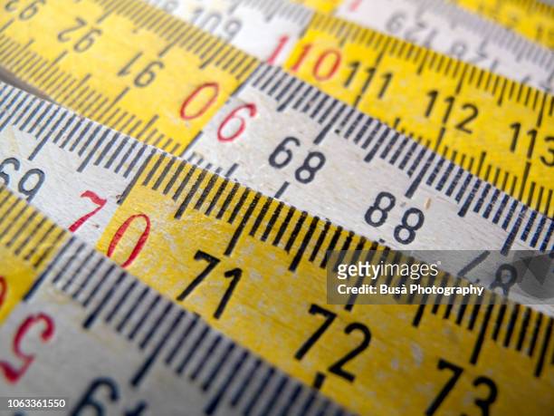 close-up of wooden white and yellow ruler - mass unit of measurement stock-fotos und bilder