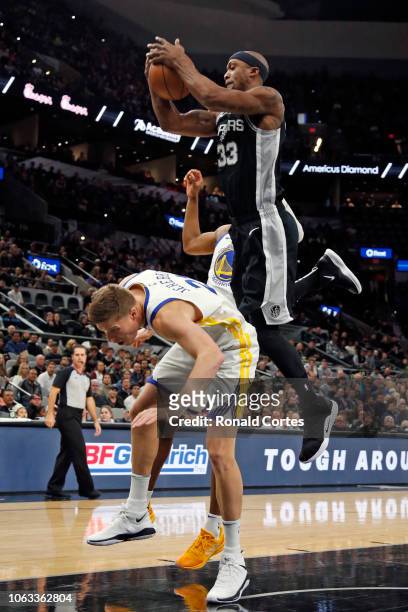 Dante Cunningham of the San Antonio Spurs grabs a rebound over Jonas Jerebko of the Golden State Warriors but was called for a foul at AT&T Center on...