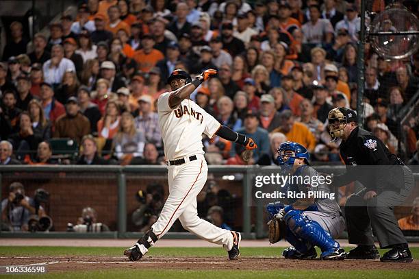 Edgar Renteria of the San Francisco Giants hits a home run in the bottom of the fifth inning of Game Two of the 2010 World Series against the Texas...