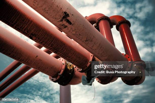 detail of giant pink water pipes, a peculiar system used to pump away ground-water from flooded foundations of construction sites. - corroded water pipes fotografías e imágenes de stock