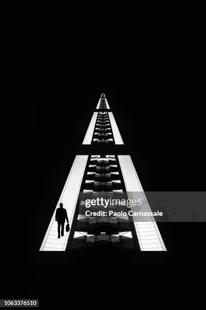 silhouette of business man walking on futuristic road - perspective abstract vanishing point stock-fotos und bilder