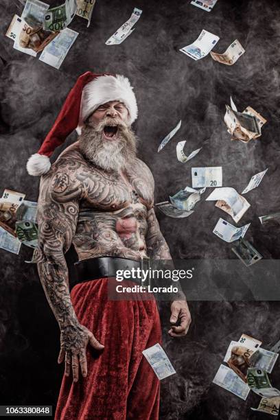 bad santa claus throwing cash - christmas cash stock pictures, royalty-free photos & images