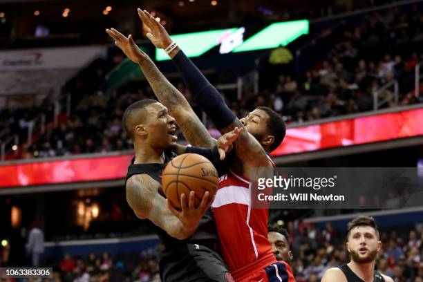 Damian Lillard of the Portland Trail Blazers shoots against Markieff Morris of the Washington Wizards during the second half at Capital One Arena on...