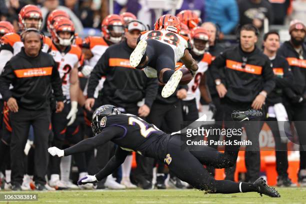 Wide receiver Tyler Boyd of the Cincinnati Bengals jumps over cornerback Jimmy Smith of the Baltimore Ravens during the fourth quarter at M&T Bank...