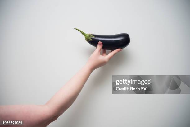 strong woman holding black eggplant - eggplant imagens e fotografias de stock