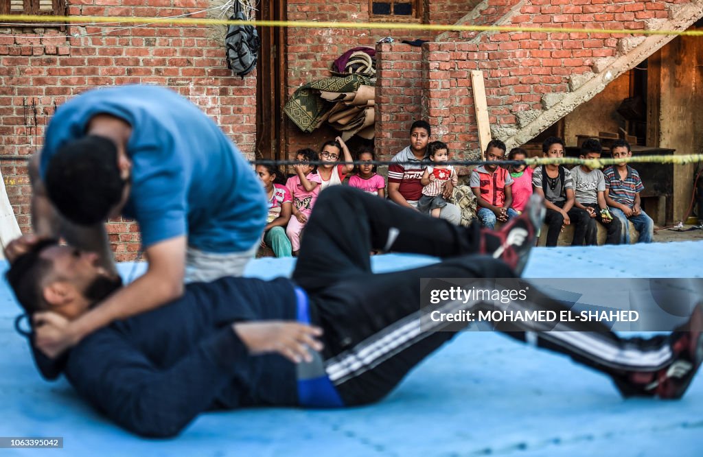 Egypt Rwm Children watch as members of the self-declared Egyptian Wrestling ...