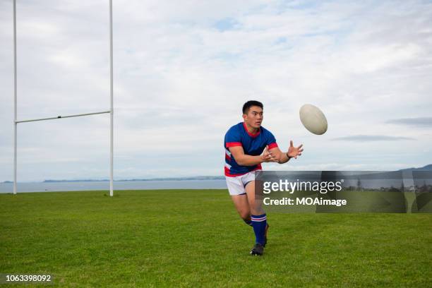 a young asian rugby player - rugbyplatz stock-fotos und bilder