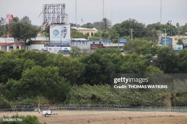 Military fencing can be seen along the Rio Grande in Laredo, Texas. The opposite side of the river is Nuevo Laredo, Mexico on November 18, 2018. -...