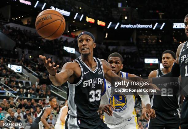 Dante Cunningham of the San Antonio Spurs tries to save the ball from going out of bounds in game against the Golden State Warriors at AT&T Center on...