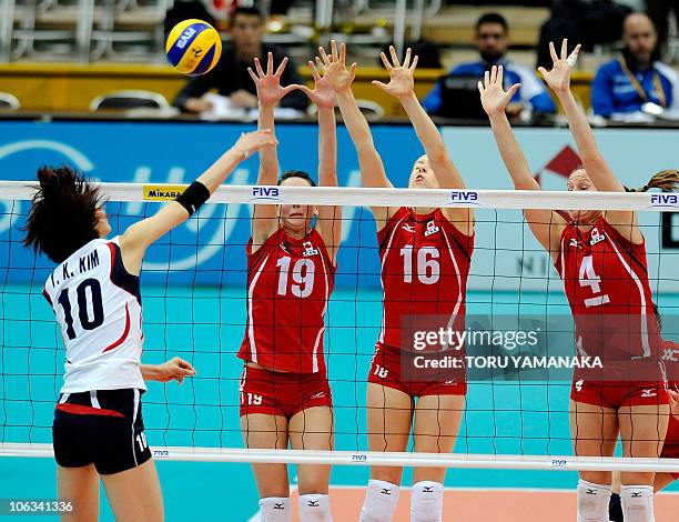 Lauren O'Reilly , Jennifer Hinze and Tammy Louise Mahon of Canada try to block the ball from Kim Yeon-Koung of South Korea during their first round...