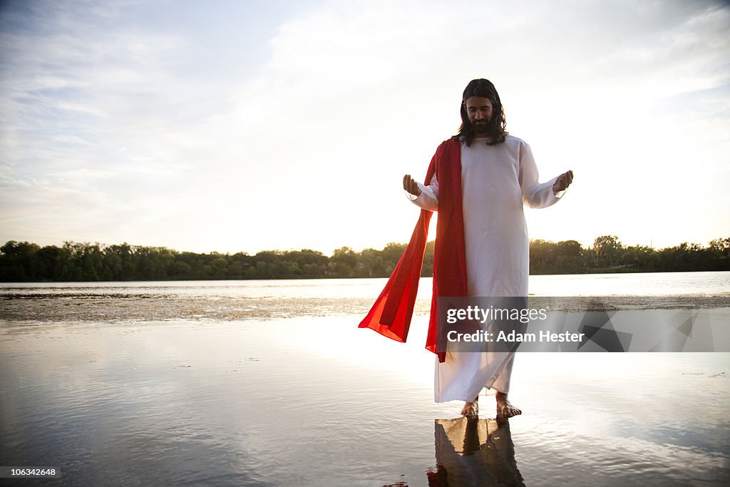 Man dressed up as Jesus on water.