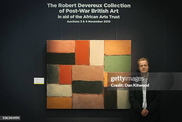 Collector Robert Devereux stands beside a piece of work by British artist Sean Scully, at Sotheby's Auction House on October 29, 2010 in London,...