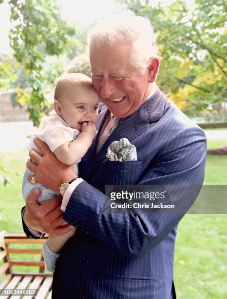 Prince Charles, Prince of Wales holds Prince Louis of Cambridge after a family portrait photo-shoot in the gardens of Clarence House on September 5,...