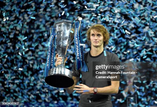 Alexander Zverev celebrates with the trophy after defeating Novak Djokovic in the singles Final during Day Eight of the Nitto ATP Finals at The O2...