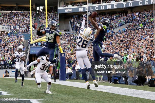 Jaron Brown of the Seattle Seahawks catches a pass for a touchdown past Casey Hayward Jr. #26 of the Los Angeles Chargers in the first quarter at...