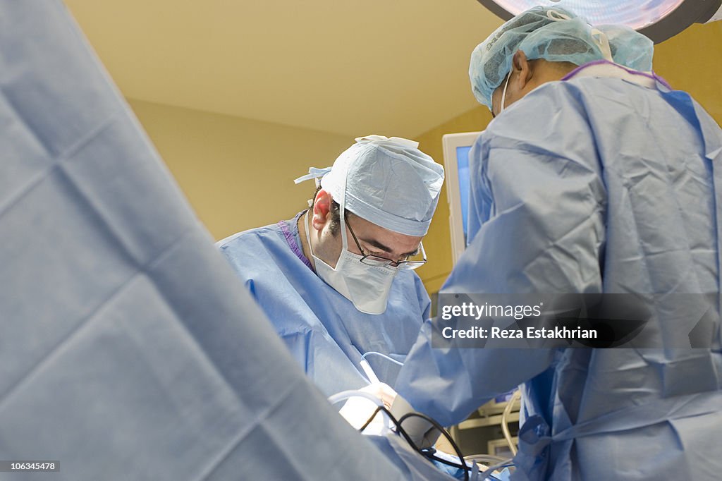 Doctor and assistant in operating room.