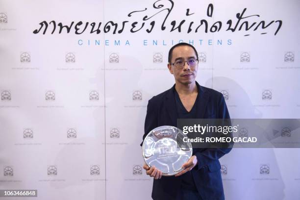 Thai filmmaker Apichatpong Weerasethakul poses with the 2018 FIAF Award from the International Federation of Film Archives during a ceremony at the...