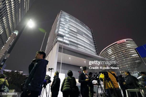 Journalists gather in front of Nissan Motor Co.'s head office building in Yokohama near Tokyo on Nov. 19 following the arrest earlier in the day of...