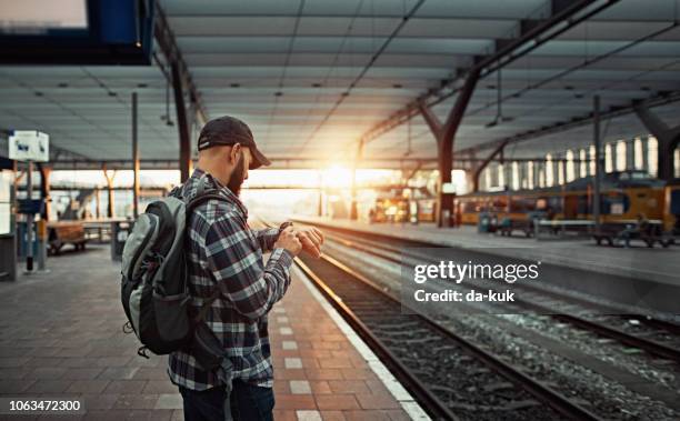 waiting for the train at railway station - rotterdam station stock pictures, royalty-free photos & images