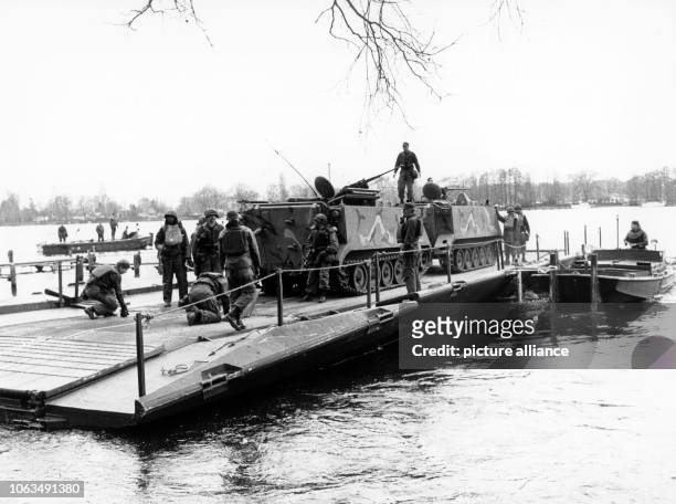 An armoured personnel carrier of the US army on a transport ferry while crossing the river Havel in Berlin during a manoeuvre of the western allied...